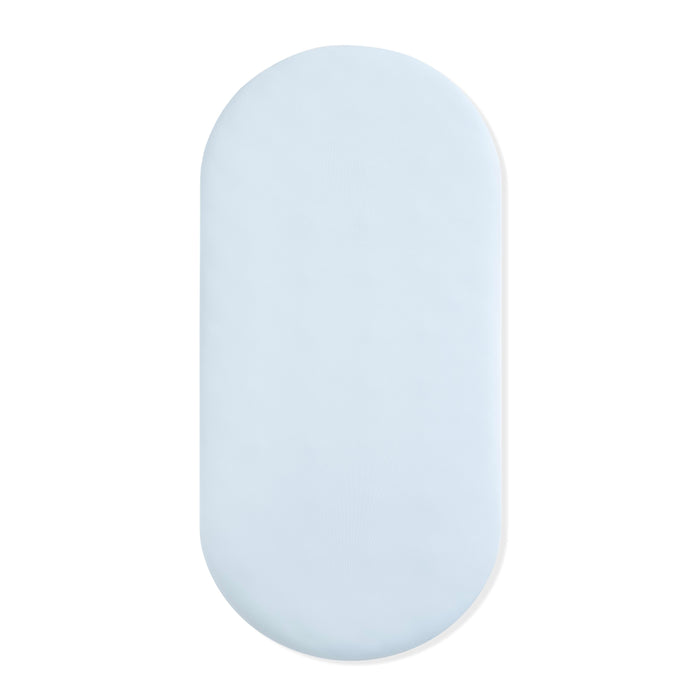 Oval Bassinet Sheet in Breeze shown on a bassinet mattress