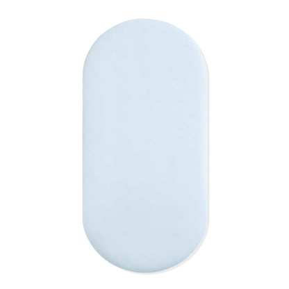 Oval Bassinet Sheet in Breeze shown on a bassinet mattress