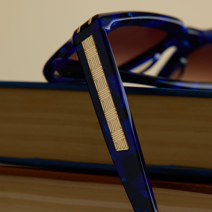 lifestyle - wicked x diff eyewear featuring the prince fiyero square sunglasses with a regal blue tortoise frame and brown gradient lenses detailed view of temple