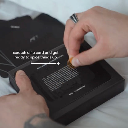 Close-up of a person scratching off a Quickies adventure card to reveal a surprise date night challenge.