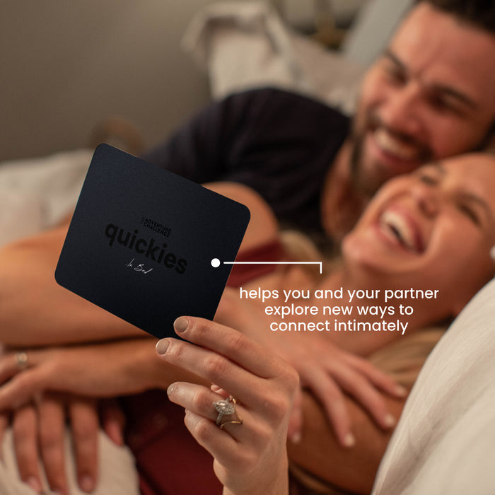Happy couple smiling as they read a Quickies adventure card together, excited to discover their next spontaneous challenge.