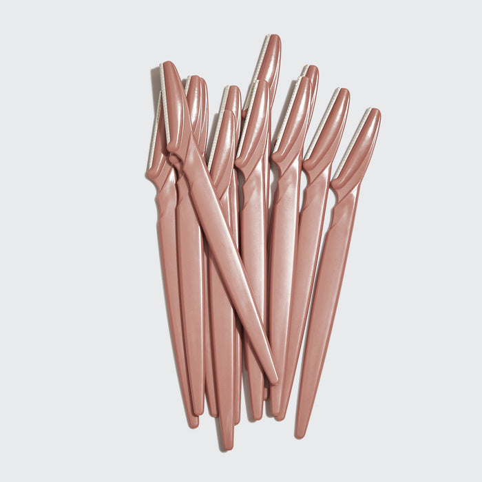 Kitsch Touch Up Dermaplaners 12pc in Terracotta with twelve blades fanned out on a light studio background
