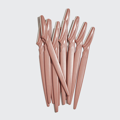 Kitsch Touch Up Dermaplaners 12pc in Terracotta with twelve blades fanned out on a light studio background