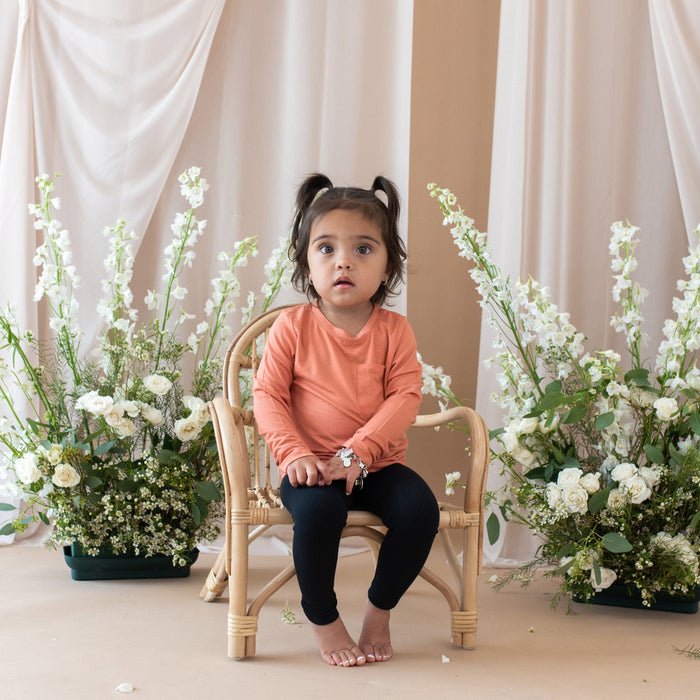 Toddler wearing Kyte Baby Ribbed Bamboo Leggings in Midnight Black
