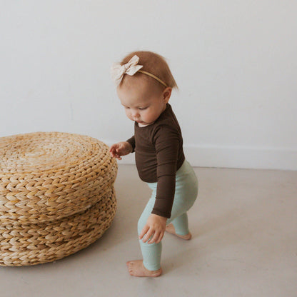 Infant Wearing Kyte Baby Ribbed Leggings with Elastic Waist in Sage Green