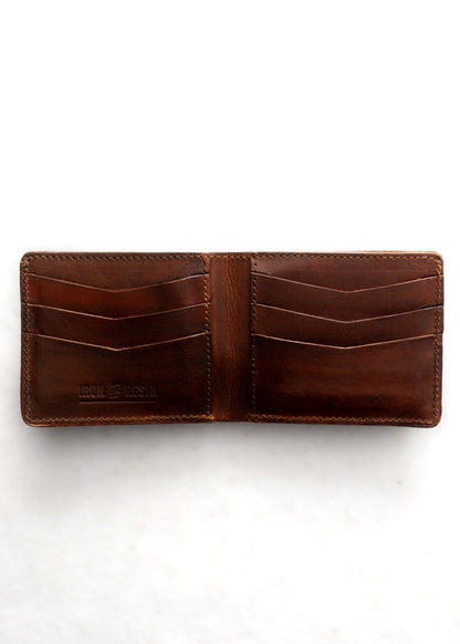 Open brown leather wallet with multiple card slots, embossed "Iron & Resin" logo, on a white background.