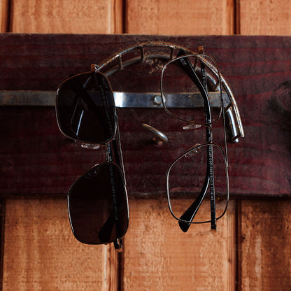 still life of yellowstone x diff eyewear featuring the rip wheeler navigator glasses with a silver frame front view