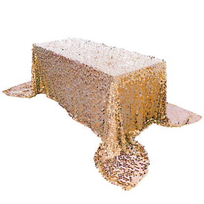 Gold sequin tablecloth draped over a table, shimmering with colorful sequins.