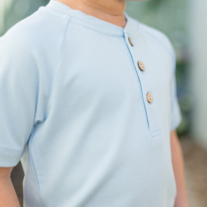 Close up of the fabric and button closures on the Short Sleeve Toddler Henley Tee in Breeze