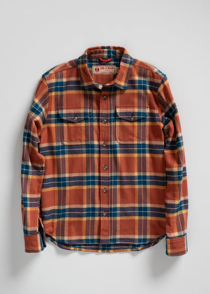 Orange and blue plaid flannel shirt with buttoned pockets, laid flat on a white background. Iron and Resin label visible.