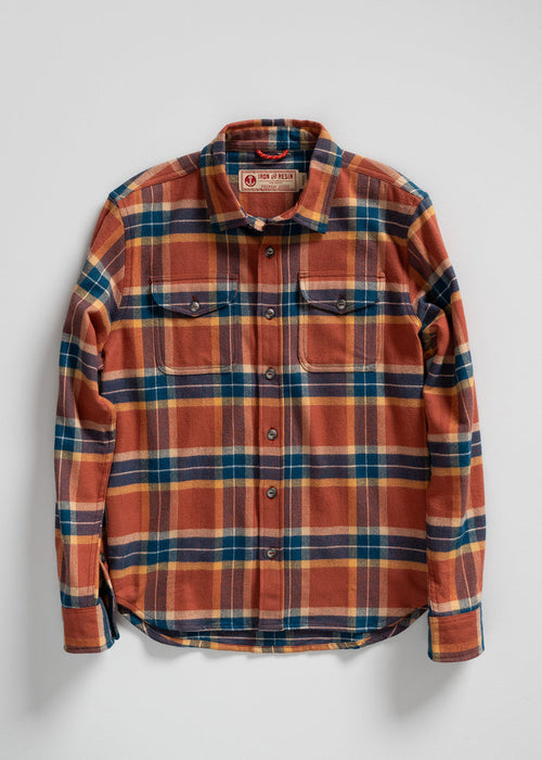 Orange and blue plaid flannel shirt with buttoned pockets, laid flat on a white background. Iron and Resin label visible.