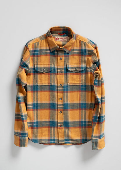 Yellow, blue, and red plaid flannel shirt with buttoned front and chest pockets, displayed on a white background.