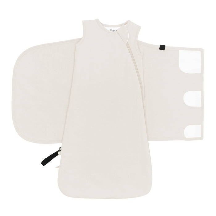 Sleep Bag Swaddler in Oat 1.0 shown unswaddled with velcro closures visible