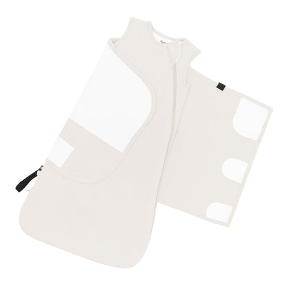 Adjustable velcro wrap shown on the Sleep Bag Swaddler in Oat 1.0