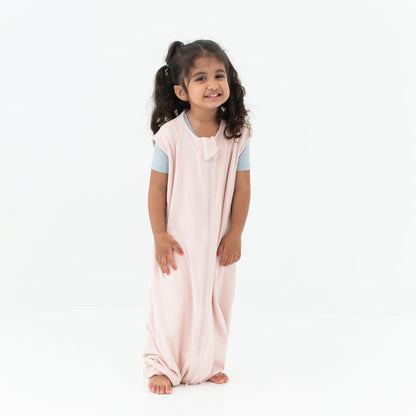 Smiling model wearing the Sleep Bag Walker in Blush 0.5