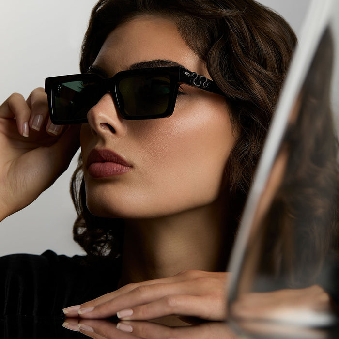lifestyle - female wearing harry potter x diff eyewear featuring professor snape 2.0 square  sunglasses with a black frame and g15 lenses angled view