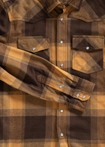 Brown and yellow plaid shirt with snap buttons and chest pockets, neatly laid out with one sleeve folded across the front.