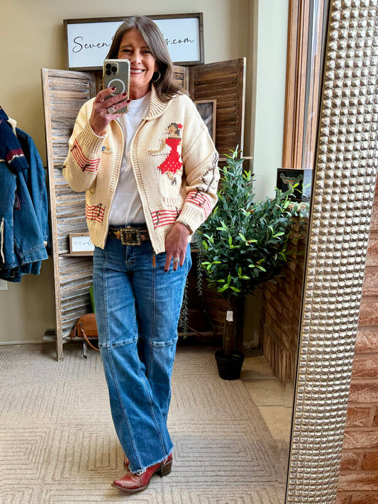 Cream knit zip-front cardigan with square-dance appliques and red-striped cuffs