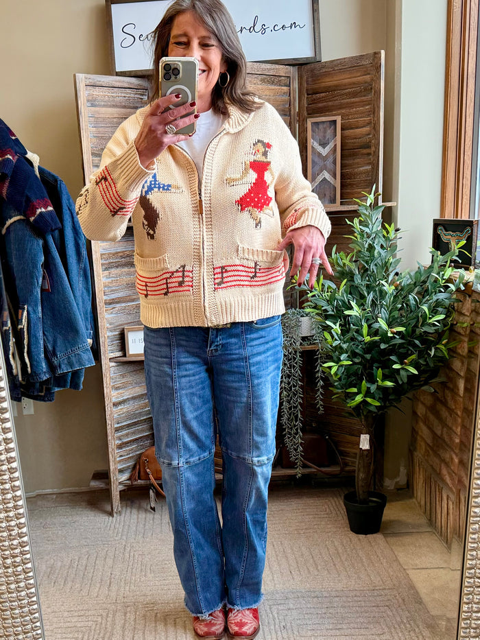 Cream knit zip-front cardigan with colorful square-dance patches and red striped trim