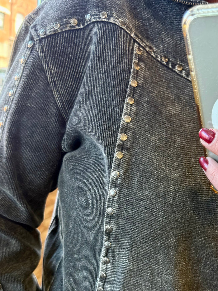 Studded button placket detail on dark charcoal 1/4-zip sweatshirt
