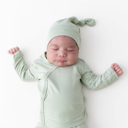 Close up of sleeping newborn wearing the Take Me Home Set with Cap in Basil