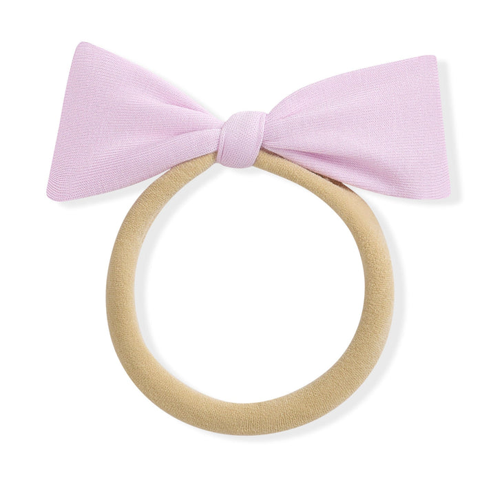 Purple bow on a beige nylon band against a white background