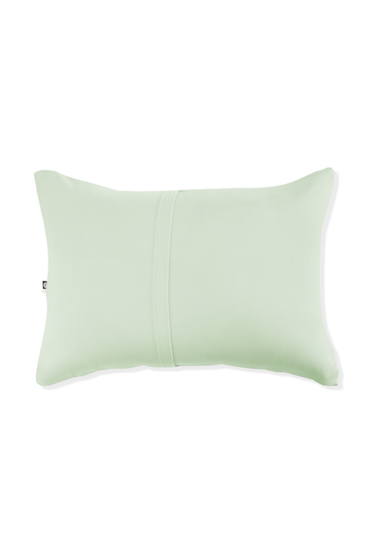 Light green pillow with envelope closure on a white background
