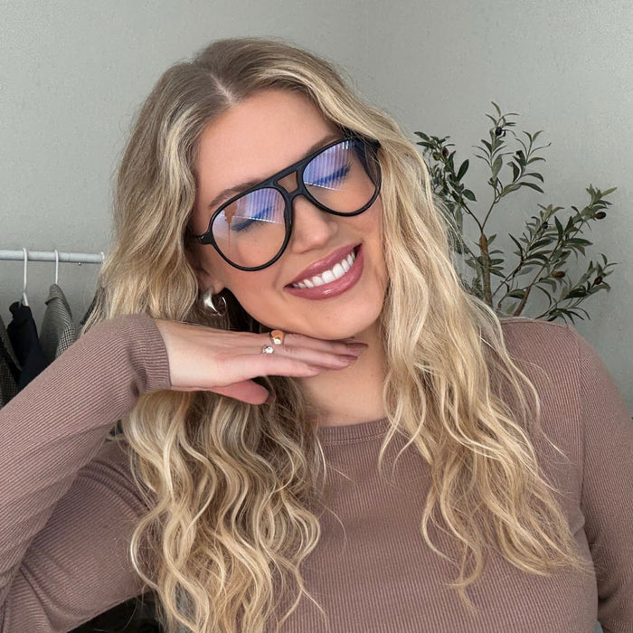 lifestyle - autumn raphael blonde woman wearing black navigator blue light glasses