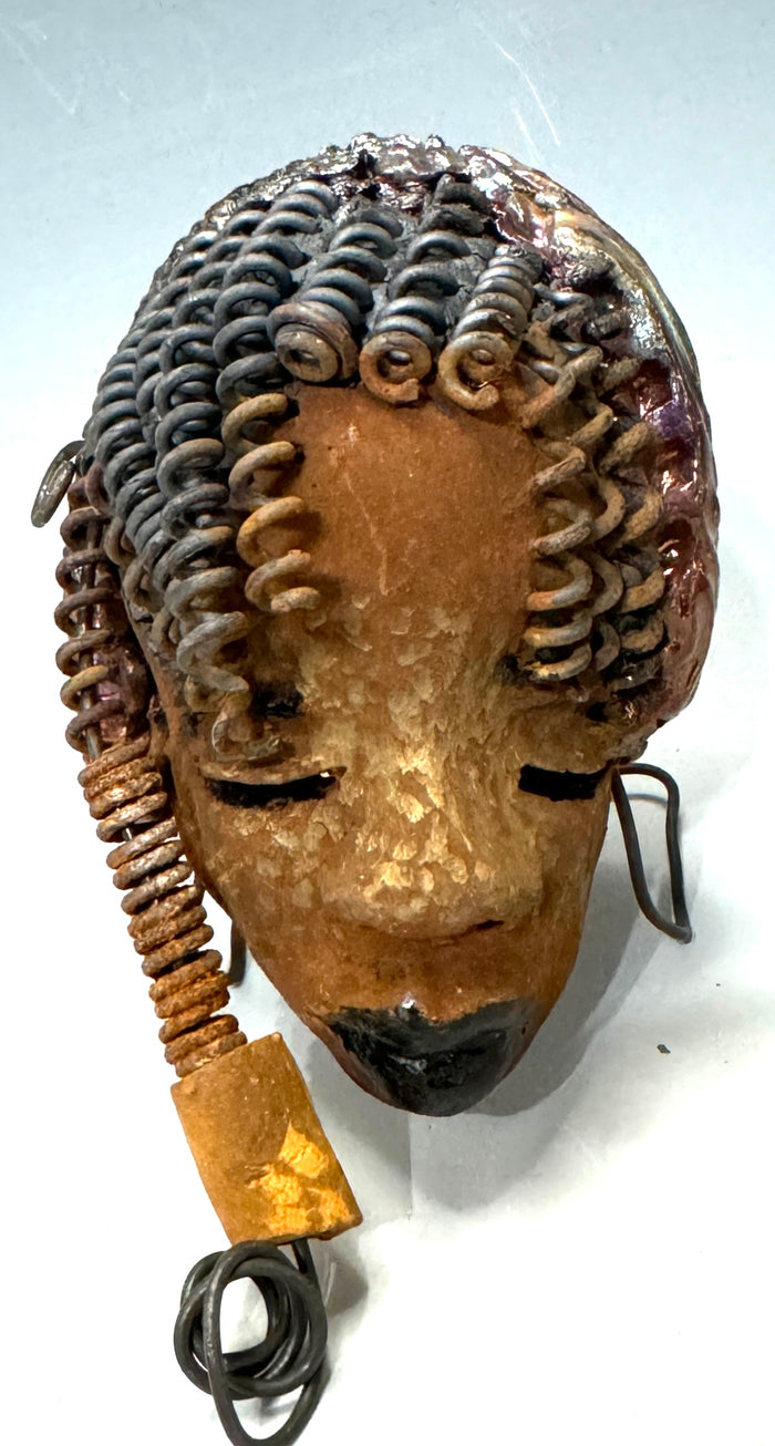 Tricia boasts a beautiful two tone honey-brown complexion, standing 3" x 5" and embellished with coils of wire and hand-made beads. Her hair is graced with hanging twists and was photographed outside amongst the trees. But of course, she will look fantastic no matter where you decide to place her.