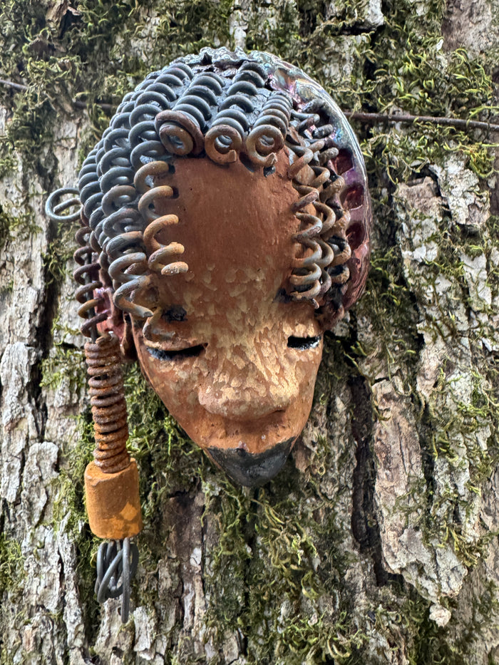 Tricia boasts a beautiful two tone honey-brown complexion, standing 3" x 5" and embellished with coils of wire and hand-made beads. Her hair is graced with hanging twists and was photographed outside amongst the trees. But of course, she will look fantastic no matter where you decide to place her.