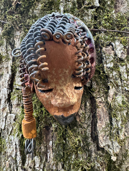 Tricia boasts a beautiful two tone honey-brown complexion, standing 3" x 5" and embellished with coils of wire and hand-made beads. Her hair is graced with hanging twists and was photographed outside amongst the trees. But of course, she will look fantastic no matter where you decide to place her.