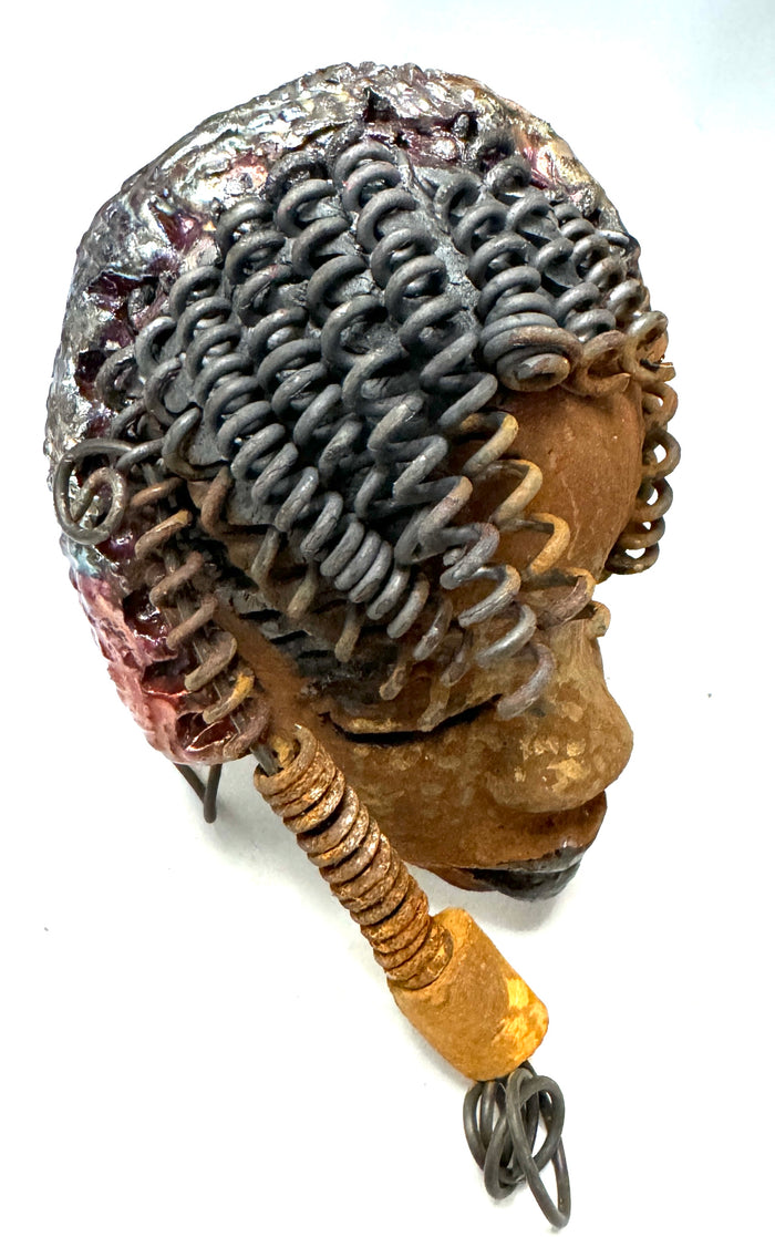 Tricia boasts a beautiful two tone honey-brown complexion, standing 3" x 5" and embellished with coils of wire and hand-made beads. Her hair is graced with hanging twists and was photographed outside amongst the trees. But of course, she will look fantastic no matter where you decide to place her.