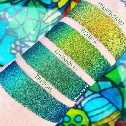 Top angled arm swatches on fair skin tone of Weathered Jewelled Multichrome Eyeshadow shifts compared to Patina, Gargoyle, Trefoil
