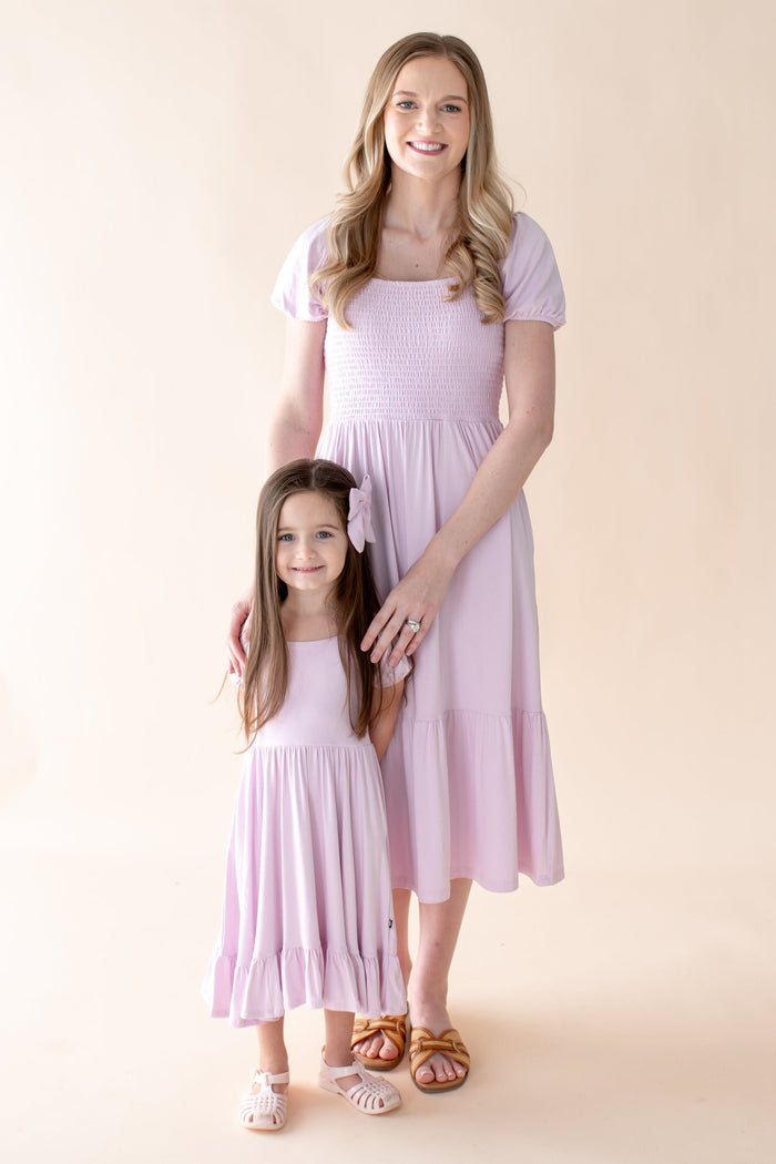 Mom and child wearing matching light purple puff sleeve smocked dresses