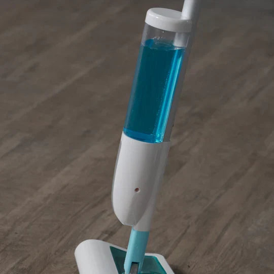 Mop with blue liquid on a wooden floor